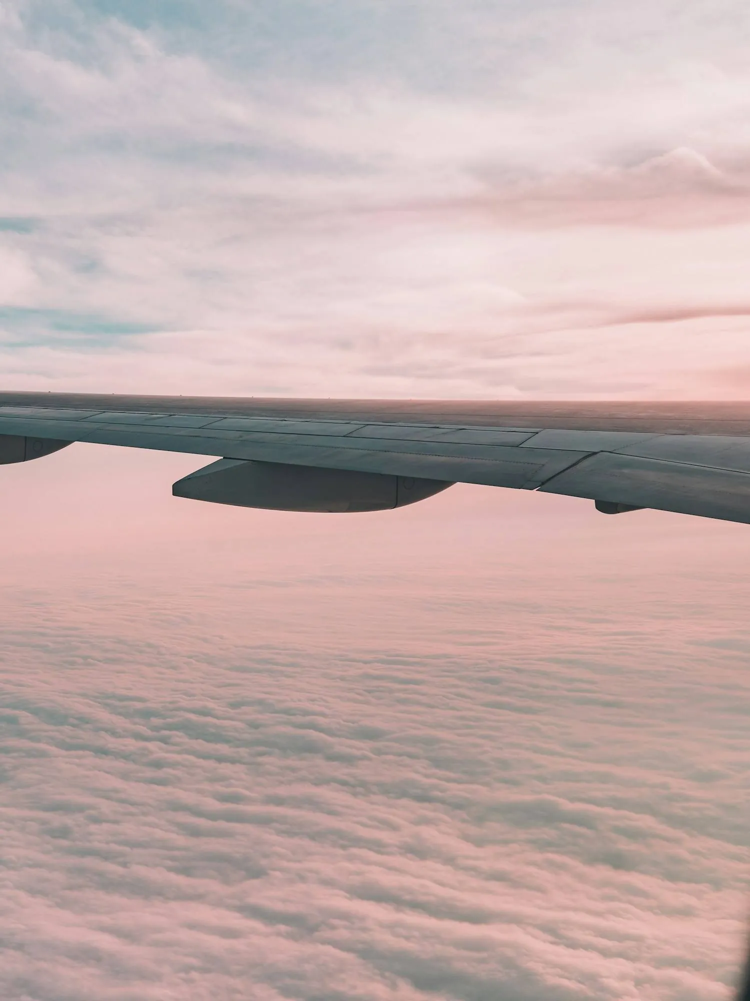 A wing above the clouds seen from the cabin window