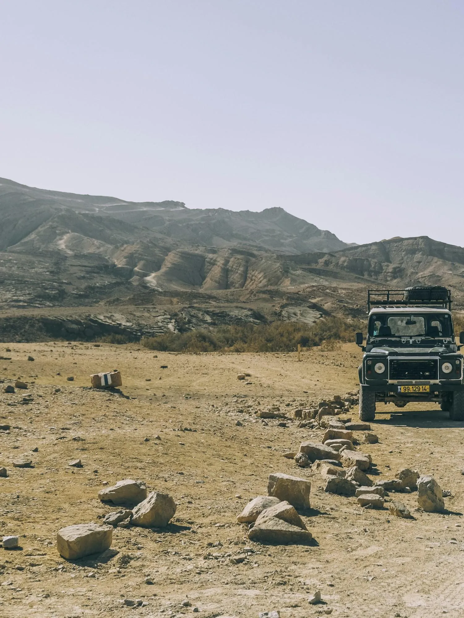 A van on an open desert road