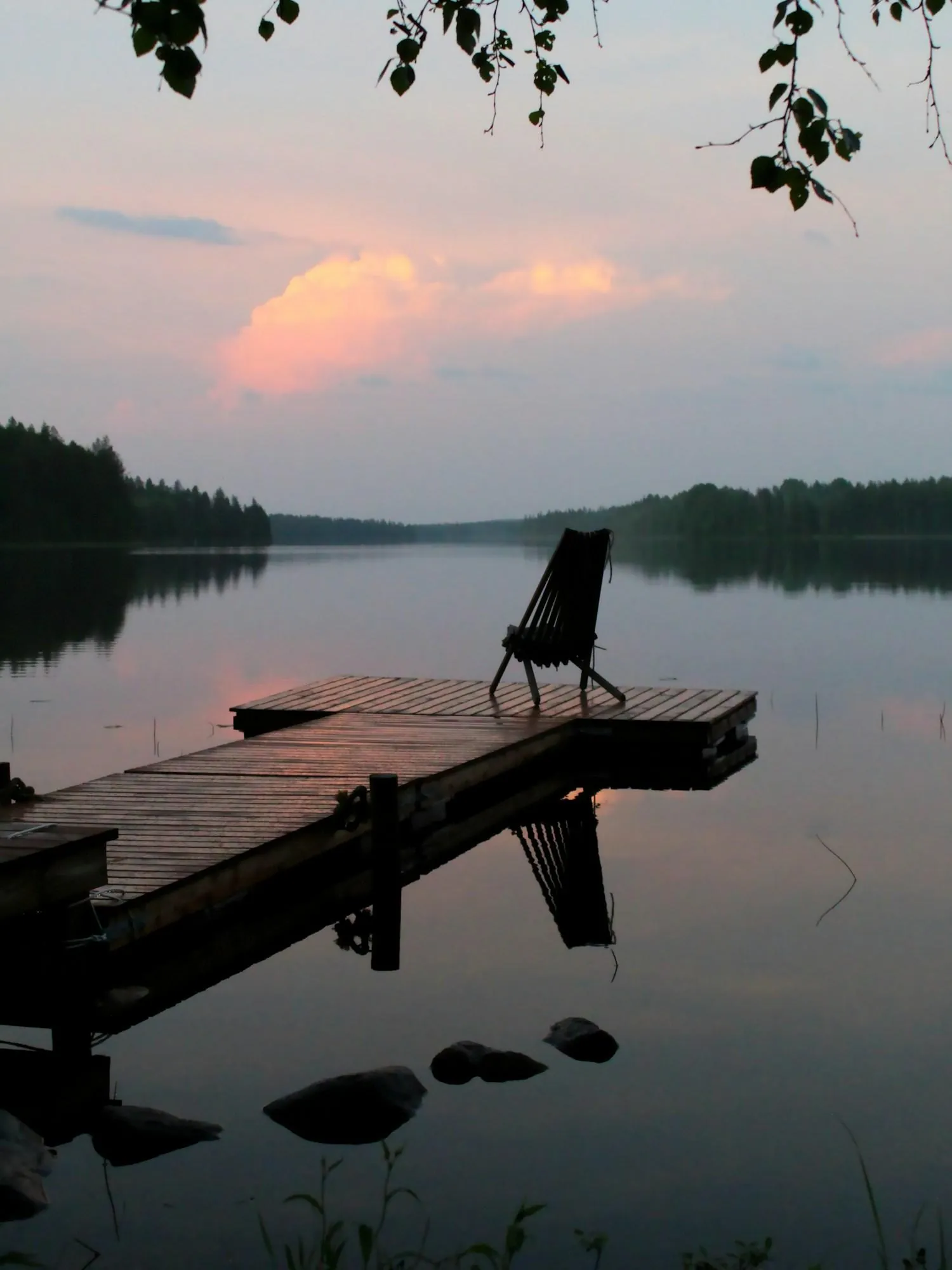Loungers beside a quiet lodge pool at dusk
